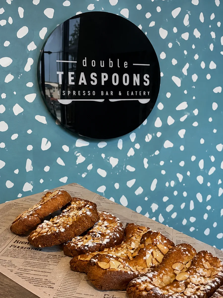 Pastries beneath the Double Teaspoons wall sign